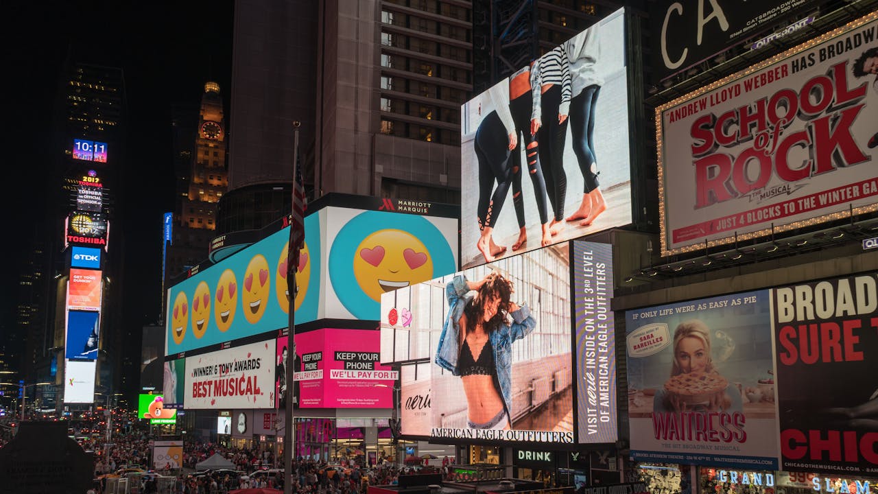 about-us Colorful billboards light up New York City's iconic Times Square at night, with vibrant ads and bustling crowds.