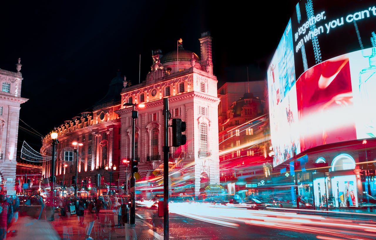 services-01 Long exposure captures vibrant city lights and nightlife at Piccadilly Circus, London.